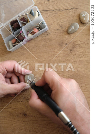 men's hands carve handmade runes men's hands carve handmade runes 105672333