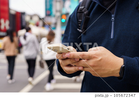 Man in downtown city street ordering taxi using smart phone app Booking taxi using application online on smart phone Man in downtown city street ordering taxi using smart phone app Booking taxi using application online on smart phone 105672347
