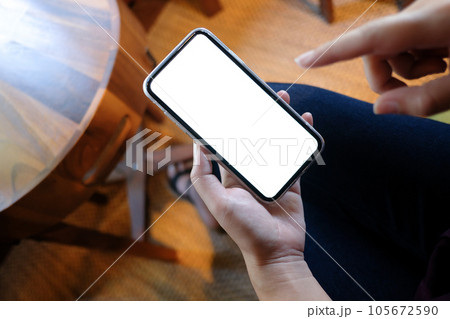 Women's hands holding cell telephone blank copy space screen. smart phone with technology concept. 105672590