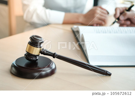 Legal counsel presents to the client a signed contract with gavel and legal law. justice and lawyer concept. Legal counsel presents to the client a signed contract with gavel and legal law. justice and lawyer concept. 105672612