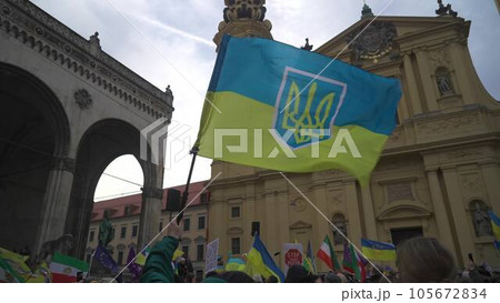 Munich. Germany. Odeonsplatz muenchen. Subject of war between Russia and Ukraine. Protesters holding yellow and blue and European Union flags at demonstration against war in Bayern Munich. Germany. Odeonsplatz muenchen. Subject of war between Russia and Ukraine. Protesters holding yellow and blue and European Union flags at demonstration against war in Bayern 105672834