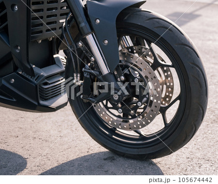 Close-up of a wheel with a motor of an electric motorcycle. Close-up of a wheel with a motor of an electric motorcycle. 105674442