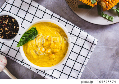 Delicious corn cream soup in a bowl on the table top view 105675574