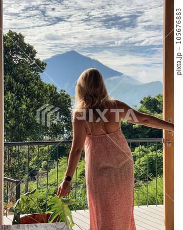 A middle-aged woman looks at the jungle and mountains A middle-aged woman looks at the jungle and mountains 105676883