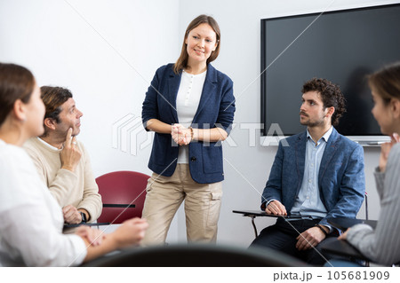 Experienced female teacher giving lecture to group of student Experienced female teacher giving lecture to group of student 105681909