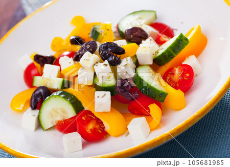 Delicious salad with tomatoes, cucumber, feta cheese and paprika Delicious salad with tomatoes, cucumber, feta cheese and paprika 105681985