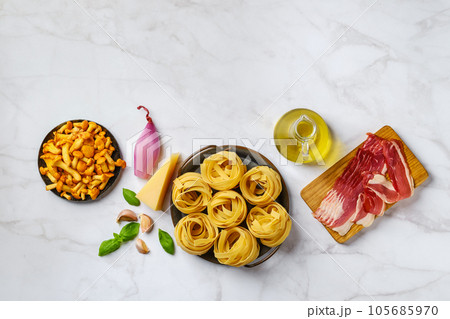 Raw fettuccine and ingredients for mushroom pasta 105685970
