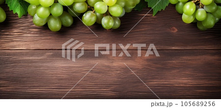 Green juicy grapes on wooden background. Green juicy grapes on wooden background. 105689256