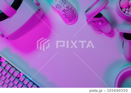 Modern gaming accessories on pink desk 105690350
