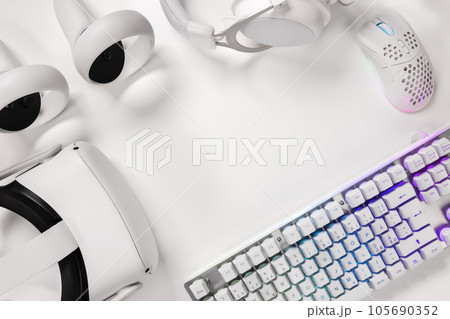 Keyboard with gaming gadgets on white desk Keyboard with gaming gadgets on white desk 105690352