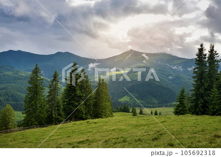 Wonderful summer panorama with mountains. Rain Clouds Above Mountains Wonderful summer panorama with mountains. Rain Clouds Above Mountains 105692318