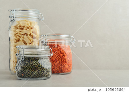 Raw mung beans, red lentils and pasta in glass jars. Raw mung beans, red lentils and pasta in glass jars. 105695864