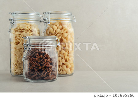Three different types of pasta in glass jars. Three different types of pasta in glass jars. 105695866