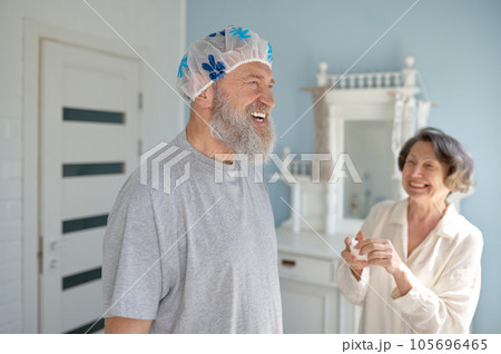 Happy laughing senior married couple fooling around in bathroom Happy laughing senior married couple fooling around in bathroom 105696465
