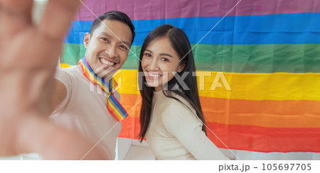 LGBTQIA friends taking selfies together with Pride flag. LGBTQIA f LGBTQIA friends taking selfies together with Pride flag. LGBTQIA f 105697705