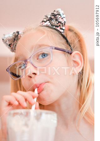 Little pretty girl seven years old drinking...の写真素材