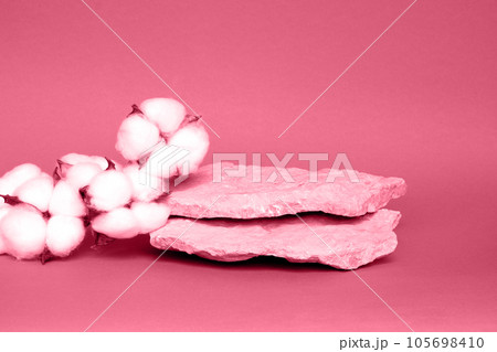 Stone Podium for promotion on Viva Magenta toned Background. Natural pedestal. Rock. Beauty product mockup. Scene to show products. Showcase, display case. Front View, soft shadow. Cotton flowers. 105698410