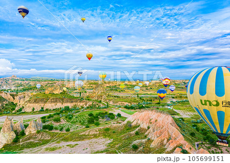 Cappadocia, Turkiye - July 07, 2023-Air balloons in Cappadocia-amazing and unreal views in valley. Cappadocia, Turkiye - July 07, 2023-Air balloons in Cappadocia-amazing and unreal views in valley. 105699151