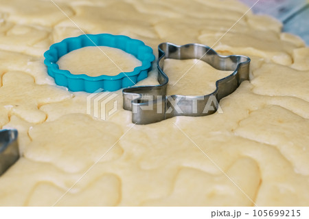 Girl bakes Christmas cookies, cooking in the kitchen. 105699215