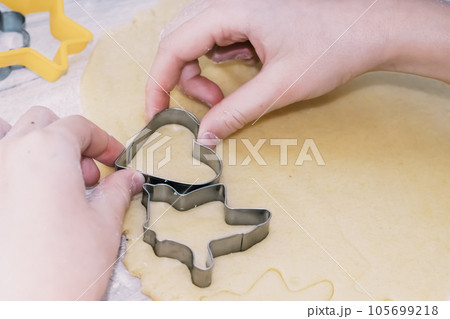 Girl bakes Christmas cookies, cooking in the kitchen. 105699218