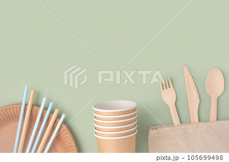 Eco - Friendly Tableware on Green Background. Top View. Plastic free Set of Brown Paper Utensil. Street Food Recyclable Packaging. Zero waste Paperware. Mockup. Disposable Take out Cup, wooden cutlery Eco - Friendly Tableware on Green Background. Top View. Plastic free Set of Brown Paper Utensil. Street Food Recyclable Packaging. Zero waste Paperware. Mockup. Disposable Take out Cup, wooden cutlery 105699498