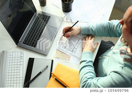 A young designer holds a pen from a tablet in his 105699796