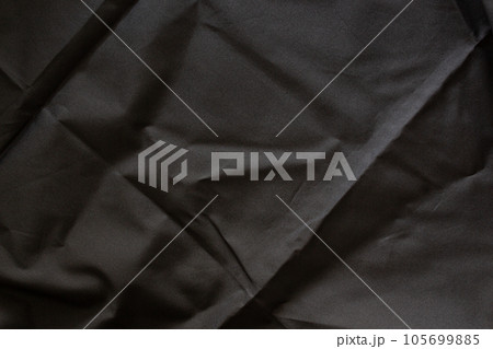 Abstract background, black folded cloth texture. 105699885