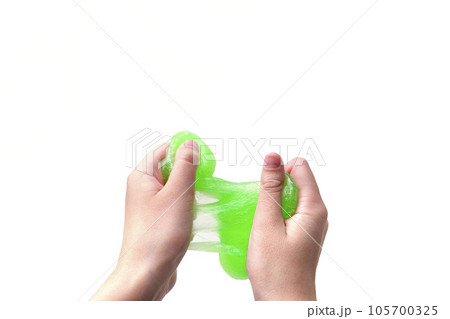 Hand Playing with textured slime on white background. Teen hand holding green shining slime with bubbles, stretching gooey substance. Teenage Girl squeezing slime toy to the sides. Liquid toy. Handgum Hand Playing with textured slime on white background. Teen hand holding green shining slime with bubbles, stretching gooey substance. Teenage Girl squeezing slime toy to the sides. Liquid toy. Handgum 105700325