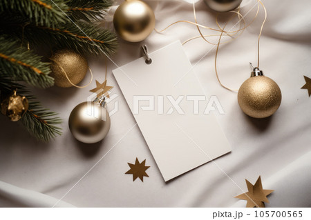 A mock-up of a white tag and a gift box with a New Year's decor with a Christmas tree 105700565