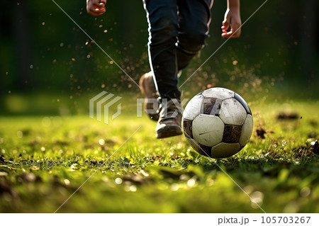 Child a boy is playing soccer. 105703267
