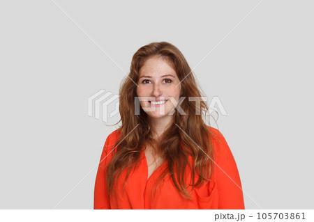 Portrait of happy pretty woman with ginger hair smiling on white background 105703861