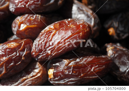 close up of fresh date fruit in a bowl on table  105704800