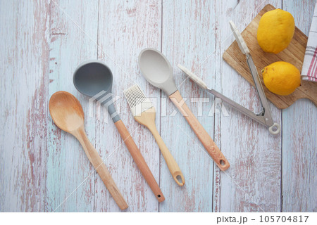 wooden cutlery fork and spoon on a chopping board on table wooden cutlery fork and spoon on a chopping board on table 105704817