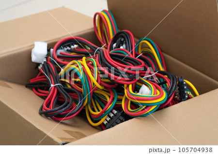 sets of multi-colored cables with connectors in a packing box 105704938
