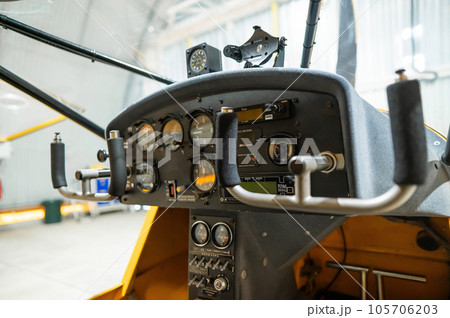 Dashboard yellow airplane glider in hangar. Dashboard yellow airplane glider in hangar. 105706203
