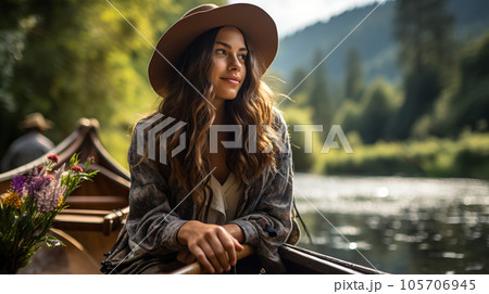 Girl traveler in a hat on a boat on the background of mountains on an azure mountain river. Pretty woman traveling a boat on beautiful mountain river among mountains. Woman sits on a boat on the lake Girl traveler in a hat on a boat on the background of mountains on an azure mountain river. Pretty woman traveling a boat on beautiful mountain river among mountains. Woman sits on a boat on the lake 105706945