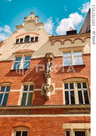 Typical old Poland buildings, low brick buildings across a narrow street, interesting old London architecture Typical old Poland buildings, low brick buildings across a narrow street, interesting old London architecture 105707351