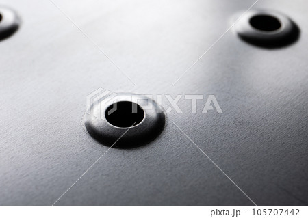 Galvanized metal plate surface with holes. Industrial style Galvanized metal plate surface with holes. Industrial style 105707442