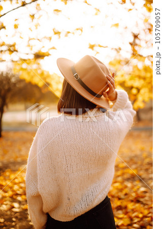 Sunny lifestyle portrait of young stylish woman walking on park, wearing cute trendy hat. Fashion concept. Sunny lifestyle portrait of young stylish woman walking on park, wearing cute trendy hat. Fashion concept. 105709057