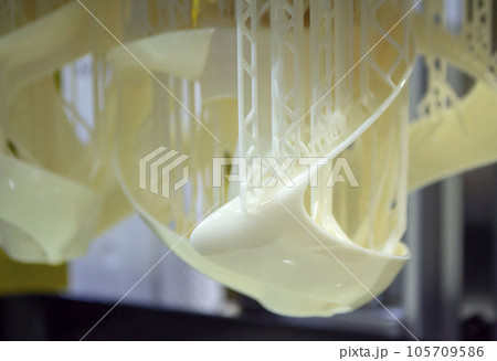 Printed models on 3D printer close-up. Objects printed on photopolymer sla 3D printer from liquid photopolymer resins on printing platform. Modern progressive additive technology. 3D printer printing 105709586