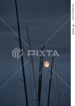 full moon across many match sailing boats at dusk full moon across many match sailing boats at dusk 105709595