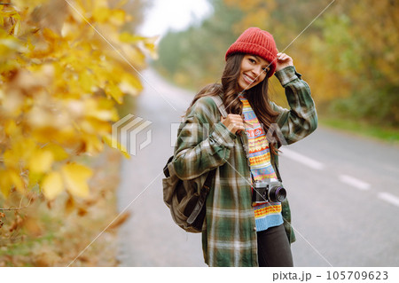 Beautiful young woman is photographed with retro camera. Rest, relaxation, travel, lifestyle concept Beautiful young woman is photographed with retro camera. Rest, relaxation, travel, lifestyle concept 105709623