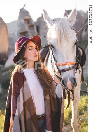 beautiful girl outdoors in the mountains with her faithful horse beautiful girl outdoors in the mountains with her faithful horse 105709731