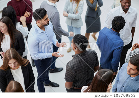 Coworkers having business meeting in a lobby 105709855