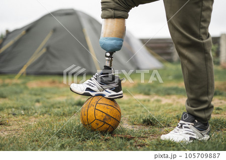 a man with a prosthetic leg is doing sports playing football a man with a prosthetic leg is doing sports playing football 105709887