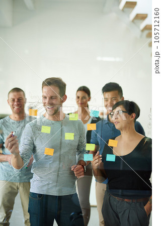 Confident manager, leader or boss talking in a meeting, workshop or presentation with sticky notes in the boardroom. Businessman talking, discussing and brainstorming with a group of colleagues Confident manager, leader or boss talking in a meeting, workshop or presentation with sticky notes in the boardroom. Businessman talking, discussing and brainstorming with a group of colleagues 105712160