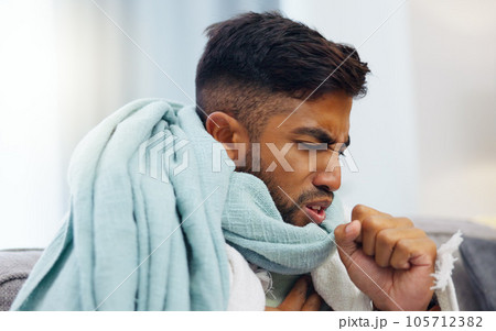 Sick, cough and healthcare with Indian man on sofa for influenza, illness and pain. Problem, medical and virus infection with guy suffering in living room at home for fatigue, disease and ache 105712382