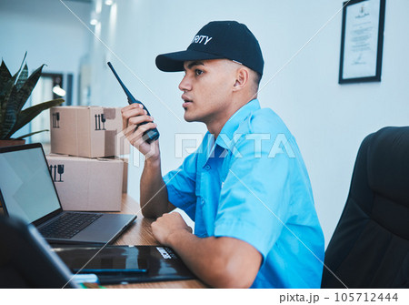 Walkie talkie, security guard and man at table in surveillance, communication in an office. Safety, protection and serious officer on radio at desk to chat on tech in police investigation service. 105712444
