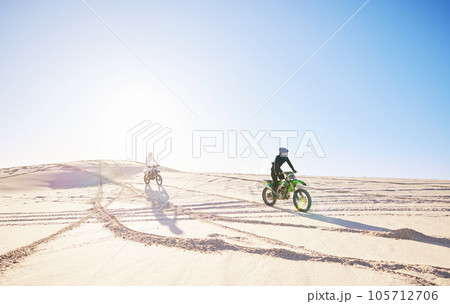 Bike, sports and race with people in the desert for fitness or an adrenaline hobby for freedom. Motorcycle, training and summer with athlete friends riding a vehicle in Dubai for energy or balance 105712706