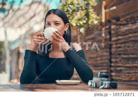 Calm, relaxed and stylish woman taking a coffee break at an outdoor coffee shop in summer. One young entrepreneur or freelancer enjoying her free time drinking tea and relaxing outside Calm, relaxed and stylish woman taking a coffee break at an outdoor coffee shop in summer. One young entrepreneur or freelancer enjoying her free time drinking tea and relaxing outside 105712871
